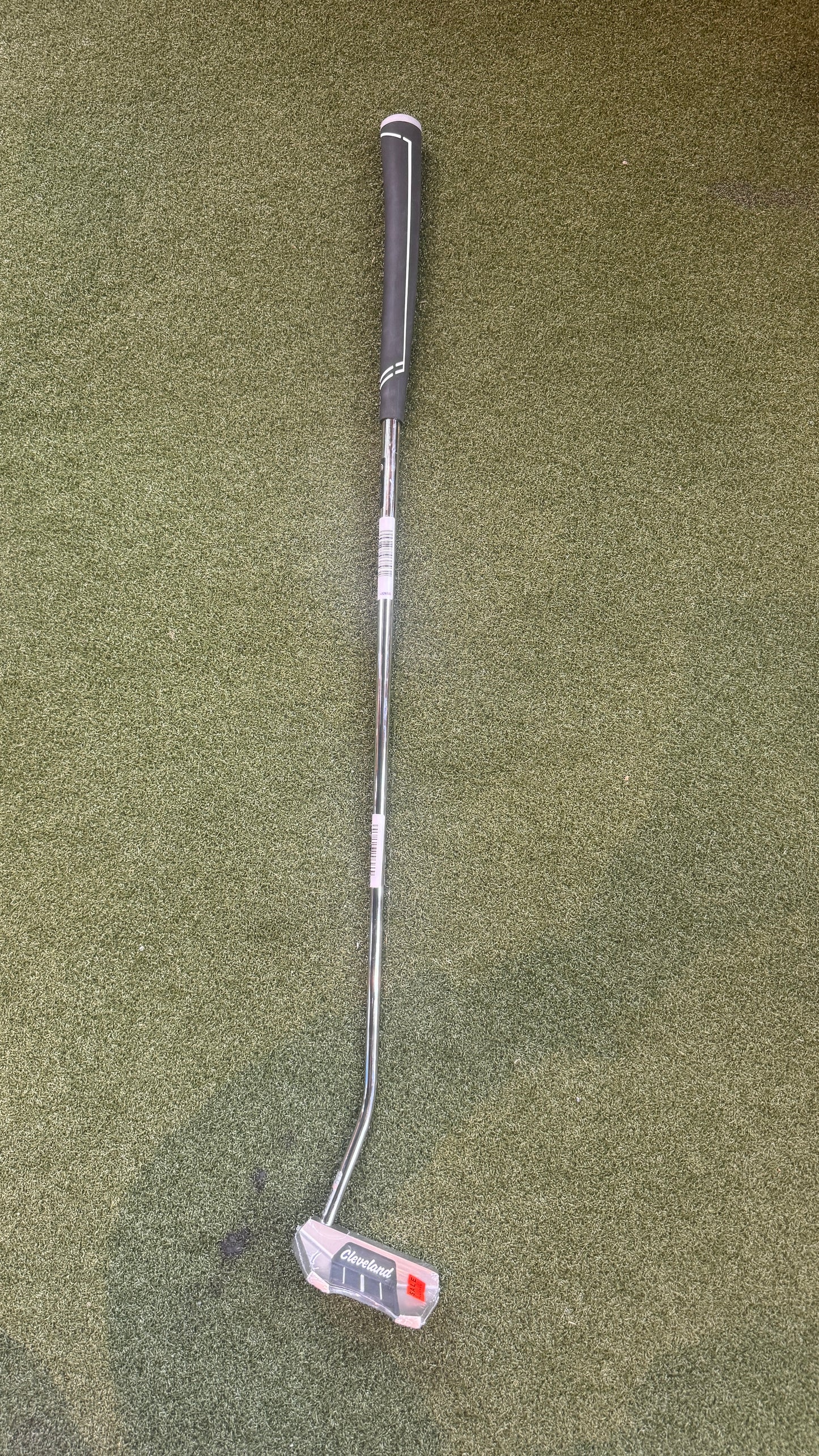 Golf club on a green grass background