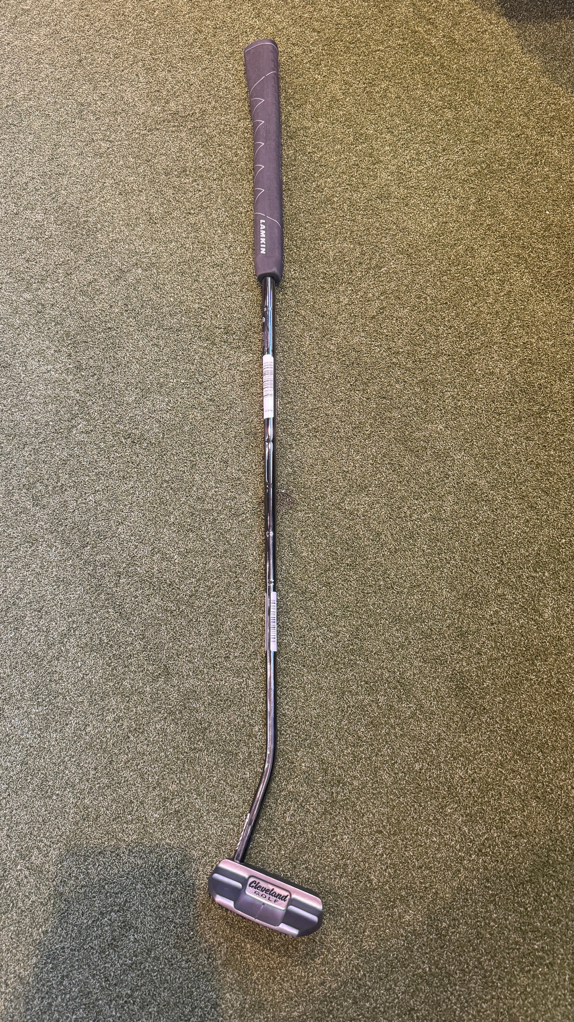 Golf putter on a textured surface